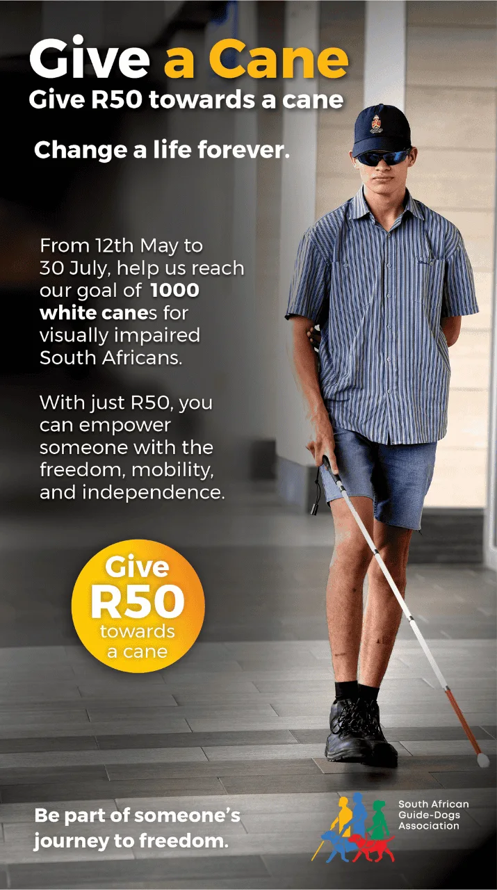 A young man wearing sunglasses, a blue cap, and denim shorts walks confidently with a white cane. Text encourages donations of R50 to provide canes for visually impaired South Africans, by the South African Guide-Dogs Association.